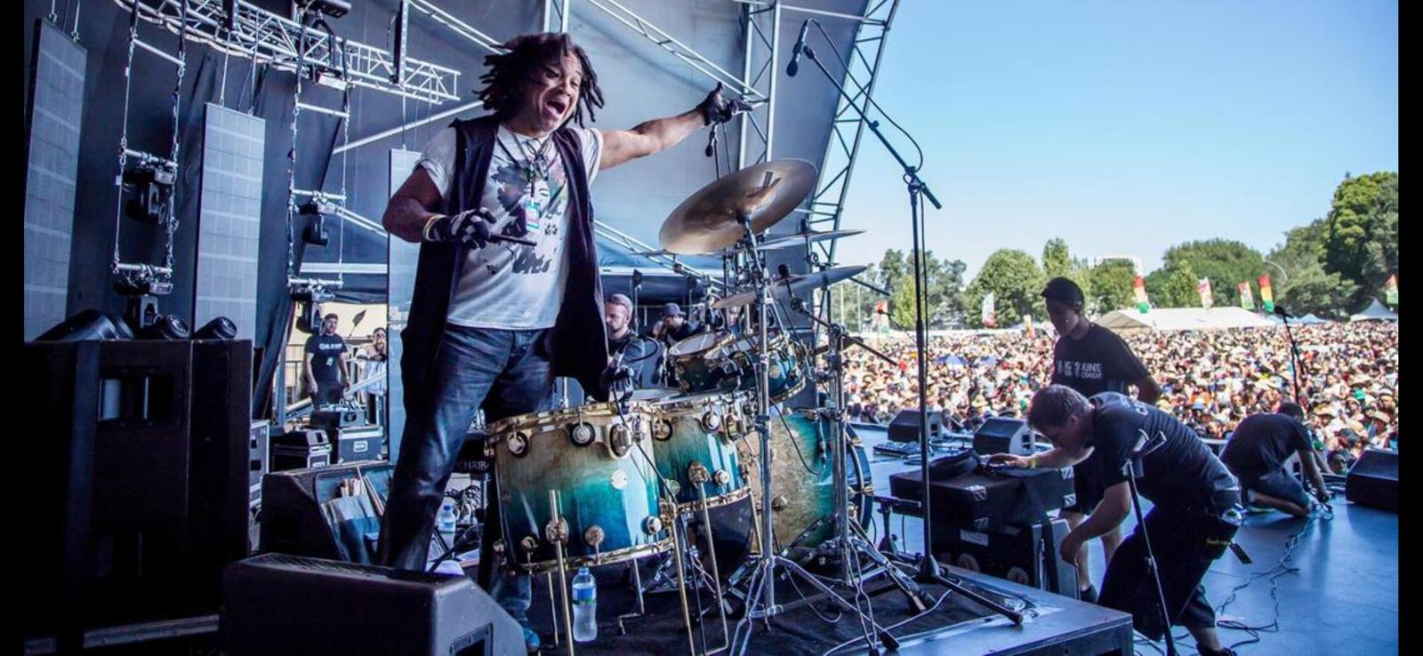 Paul KasticK performing at a festival with drums